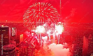 Multicolor Fireworks Displays over the Sky City. New Year's Eve. Skyscraper and Cityscape Celebrate Night Lights from an aerial drone perspective