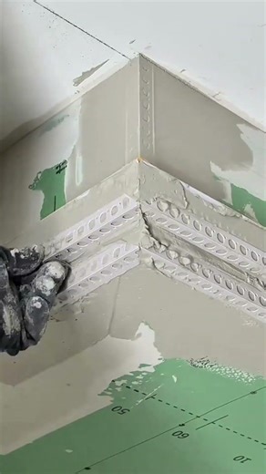 applying corner beads and plaster to reinforce wall edges for a clean and straight structural finish