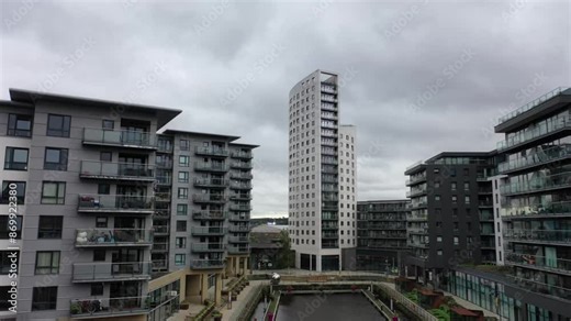 Aerial drone footage taken in the city of Leeds in West Yorkshire in the UK showing the area known as the Leeds Docks with the canal and high rise building apartments