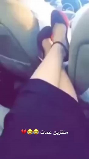 Elegant Red High Heels Showcased in Car Interior