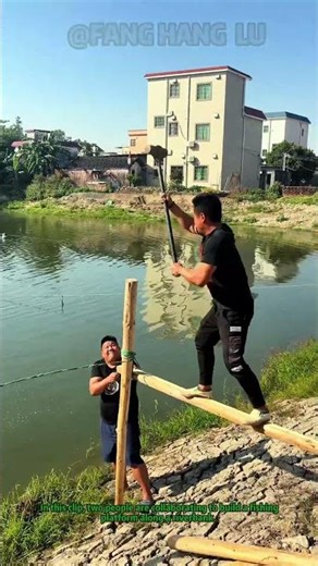 Building a Fishing Platform: Riverbank Stake Installation With Teamwork #Shorts #FishingPlatformDIY