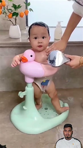 This kid is playing with a ball while taking a bath 🚿 and Short