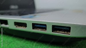 White USB cable that is unplugged from the USB port on a laptop or notebook