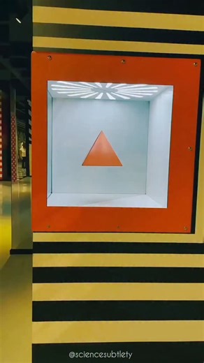 Science Subtlety on Instagram: "This optical illusion is a classic example of anamorphic sculpture, where a single physical object is engineered to project two entirely different shapes depending on the viewer's line of sight. The object is neither a solid pyramid nor a solid cube; instead, it is a complex, multi-faceted geometric form crafted with precise "forced perspective." From the front, the object’s edges and planes align perfectly to form the silhouette of a triangle, but as the viewer m