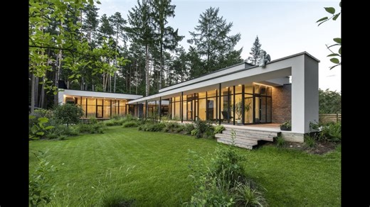 A serene house lets pine trees grow through its decks and roofs