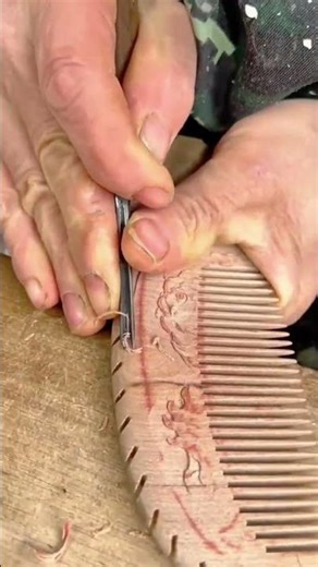 carving detailed dragon patterns on a wooden comb using a sharp metal chisel #shorts