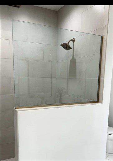 This primary bath is just begging for the fish tank meet-cute music in R J isn’t it? Shown: custom tiled shower with half-wall glass and dual shower heads. Tile: PHX New Yorker 2”x2” shower floor, 12”x24” shower walls 4” square tillable shower drain grate. Vanity: DuraSupreme Bria series in the Homestead door and Quartersawn White Oak with Coriander stain and MSI Q Quartz vanity top in Calacatta Miragio design. Village Home Stores 🤝 Hazelwood Homes