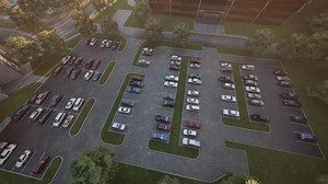 Aerial view of a busy parking lot with various cars during daytime