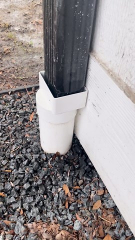 French drain pipe overwhelmed by gutter water during heavy raining.