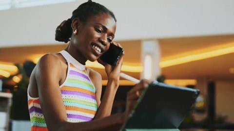 clip-4006058635-ambitious-black-female-professional-multitasking ...