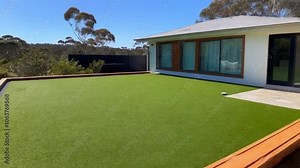 Charming Australian Home with Artificial Grass Lawn and Timber Edging in Front Yard