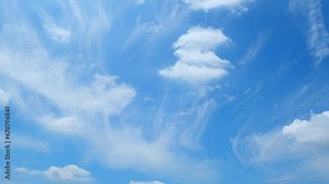Blue sky time-lapse - The heavens in motion. Our timelapse video reveals the dynamic interplay of a vivid blue sky and swirling clouds, showcasing nature's constant evolution. 4K.
