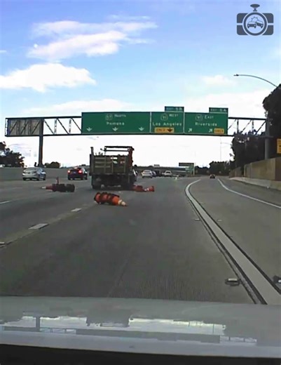 A truck drops a whole bunch of traffic cones on the road. | Dashcam Lessons