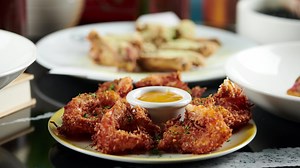 Housing an explosion of colour, cocktails and playful eats, this place knows how to have fun. From chicken and waffle dippers to plant-based poutine – there's something for everyone. And when you're done munching up a storm, head down to The Basement and hit the dancefloor  50% off the first table of the night  ca.firsttable.com/the-living-room | First Table | Facebook