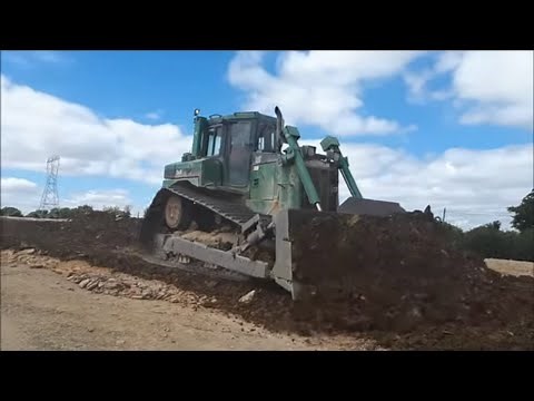 Caterpillar D6 dozer at work pushing gravel for road construction