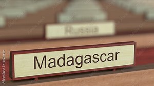 Madagascar name sign among different countries plaques at international organization. 3D rendering
