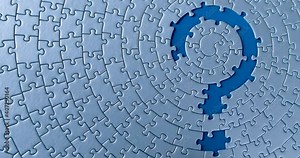 Gray circular puzzles stacked on blue background. Female hand is pulling out piece, creating question mark sign. Suspense, obscurity, problem, issue, task, business solution decision search concept.
