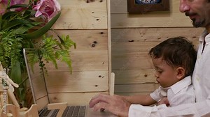 father teaching his son on laptop baby learning in computer with his father Stock Video