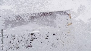 frost and snow on window, in winter. Melting and stacking. Time lapse
