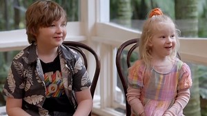 The parents are touched as the kids describe them to a cartoonist