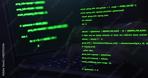 Hacker hands typing on a keyboard, close up view - Man coding using a notebook with overlayed text of meaningless code - IT and technology concepts