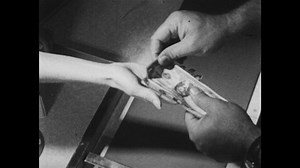 1950s: Grocery store. Cashier hands change to woman. Woman puts money in purse. Little boy stands. Men look at fishing net.