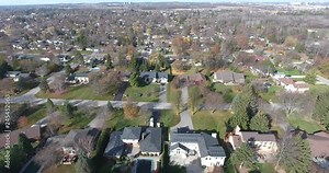 Flying Over House With Solar Panels Towards Houses With Manicured Lawns 4 K