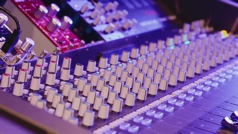 clip-4016298157-studio-mixing-console-displays-numerous-knobs-sliders