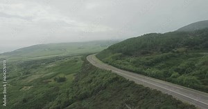 Wide drone shot of the A9 road with traffic moving in both directions on the Scotland North Coast 500 route