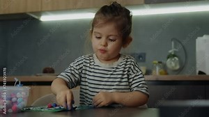 Little girl making handcraft at a table at home. DIY paper handicraft, hobby concept, gift idea. Process of creation, creativity. Stock Video