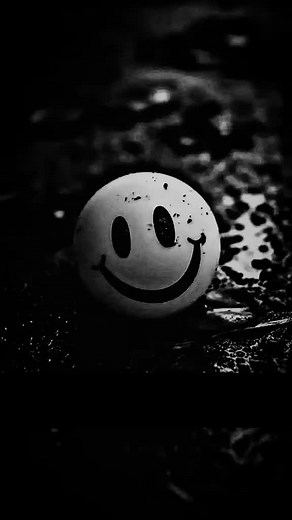 Smiley Face Balloon Floating in Dark Background