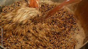 Mashing malt and maintaining temperature pauses during the preparation of homemade beer close-up
