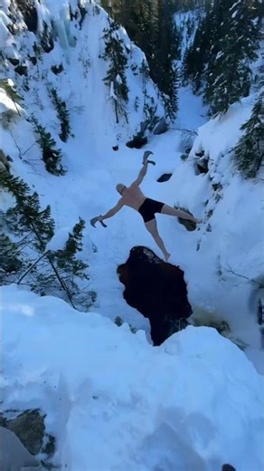 Viking Cold Plunge: Man Jumps Off Snowy Cliff with Axes into Freezing Water