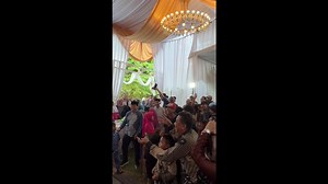 Wedding photographer gets soaked when bride and groom throw water bombs into crowd