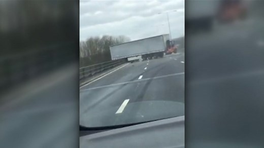 M25 crash: The moment a lorry is left hanging over a bridge