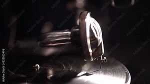 close up old vinyl player. the needle stands on a rotating disc of a vintage gramophone. Video footage. dark black background. Retro style party. artificial lighting backlight. dust in the air Stock Video