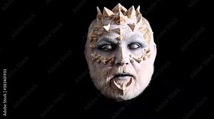 Scary Halloween man, face close-up. Demon for Halloween party. Devil with horns. Demon or satan on black background.