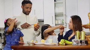 Family enjoying breakfast together in their kitchen