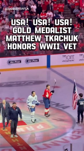 This is what America is all about! 🇺🇸❤️🤍💙 The crowd chants "USA!" as Team USA men's hockey star Matthew Tkachuk carries the flag to 101-year-old WW II veteran Jim Sileno and handed him the game puck at the Florida Panthers game. God bless Matthew and all those who've served! 🇺🇸🙏🏅 SORRY for the terrible pronunciation of his last name lol | Caleb Parke