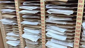 Many paper documents are in numbered cells.