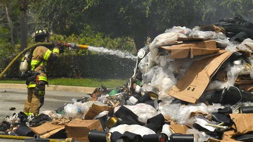 See the video: Waste Management driver forced to unload garbage that burst into flames