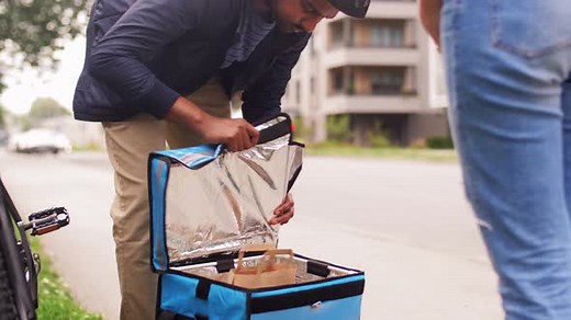 Happy Food Delivery Man Giving Order to Customer