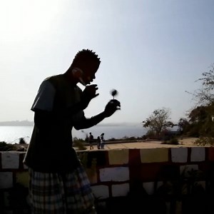 Saliou playing the aslatua on Goree Island. Pronounced “us-la-twa”, this simple and unique traditional instrument (also known as asalato, kashaka, cascas, televi, kasso-kassoni) originates from Ghana. Each pod is a gourd from the Swawa tree. When the gourds dry and fall off the tree, children collect them then give them to elders who hollow and fill them with orange pebbles from the iron-rich soil of the Sahel. Aslatua are played by holding and shaking one gourd in the palm while swinging the se