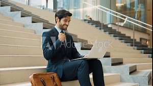 Executive manager celebrate successful project or getting promotion, getting new job. Professional business man express feeling joy and happy while using laptop checking increasing sales. Exultant.