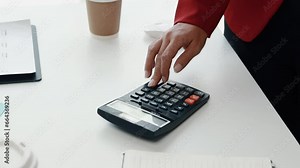 Financial businessman presses calculator to calculate income and expenses and prepare company financial statements, using accurate numbers calculator. Financial management concepts.