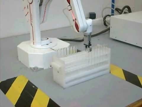 R12 robot arm moving test tubes in a rack