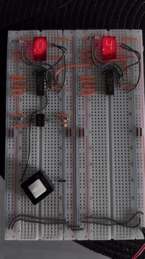 A decimal counter = TIL311 displays, 7490 ICs, and a push button triggering a pulse from a 555 timer