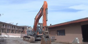 Sherman demolishing two dilapidated buildings