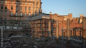 Restoration of ruins of Roman forum. Reconstruction of antique column inside Roman forum. Column surrounded by modern metal scaffolding. Concept of restoration historic cultural landmarks, slow motion