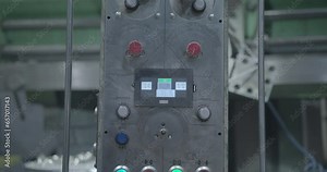 Close-up of the controls of a metal milling machine in a factory setting. Buttons and switches on a switchboard, offering a glimpse into the precision machinery that powers industrial operations.